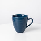 Elegant dark blue ceramic coffee cup with a wavy pattern
